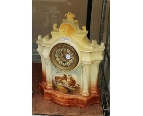 A CERAMIC CHIMING MANTLE CLOCK DEPICTING SHEEP WITH WINDING KEY 
