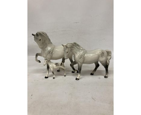 A BESWICK MODEL OF A DAPPLE GREY STALLION, MARE AND FOAL (A/F) 