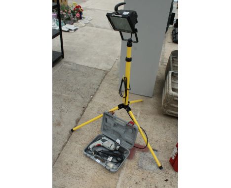 A TRIPOD WORK LIGHT AND A PROFORMANCE ELECTRIC DRILL WITH CASE 