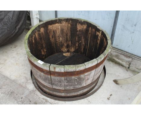 AN OAK AND METAL BANDED ROUND HLAF BARREL PLANTER 