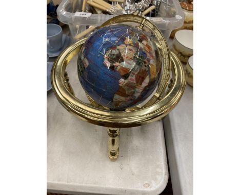 A GEMSTONE GLOBE WITH COMPASS TO THE BASE 