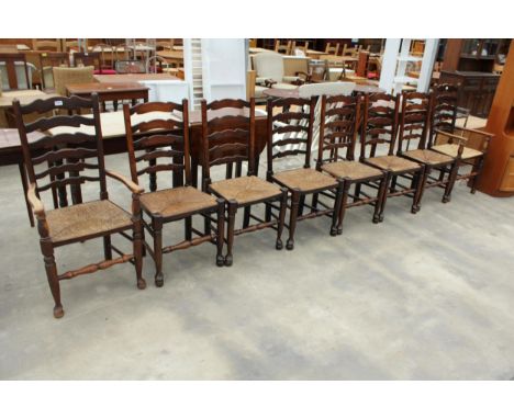 EIGHT ELM LANCASHIRE STYLE LADDER BACK DINING CHAIRS WITH RUSH SEATS, TWO BEING CARVERS 