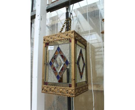 A VINTAGE AND ORNATE BRASS AND STAIN GLASS CEILING LIGHT SHADE (A/F) 