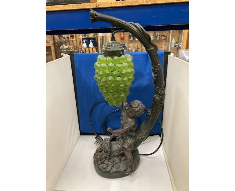 A CAST RESIN FIGURAL TABLE LAMP WITH HANGING GRAPE DECORATION (A/F) 