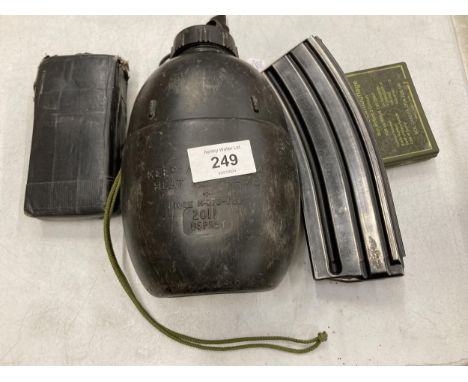 A MILITARY SPRING LOADED BULLET CASE, COMPASS WATER BOTTLE AND FACE PAINT 