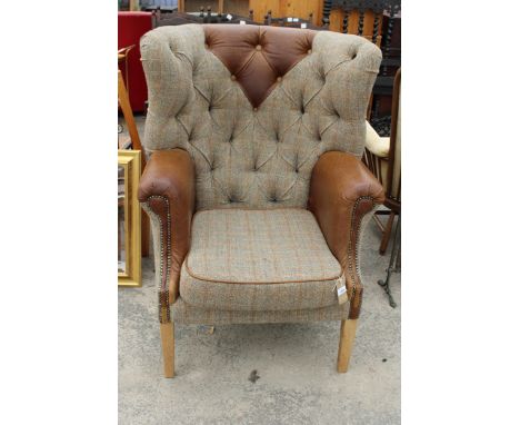 A 'HUNTING LODGE' HARRIS TWEED AND LEATHER BUTTON-BACK WINGED EASY CHAIR WITH BRASS STUDDING ON TAPERING LEGS 