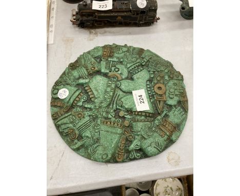 AN ORNATE HEAVY DESIGNER AZTEC EMBOSSED PLATE, DIAMETER 24CM 