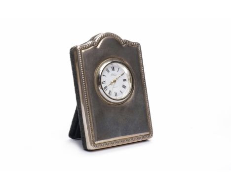 SILVER EASEL BACKED TRAVEL CLOCK maker 'RC', London 1994, with shaped frame, the dial with Roman numerals and pierced hands, 