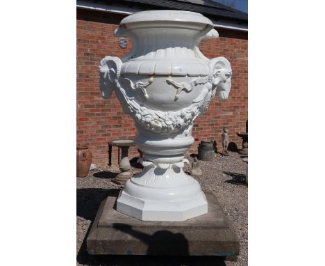 Very large metal urn depicting Rams heads on stone base - Approx height: 200cm