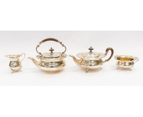 A George V silver four piece tea set comprising teapot, kettle, milk jug and sugar bowl, circular bodies with ornate pierced 