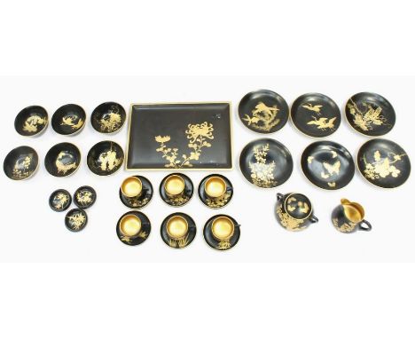An early 20th century Japanese bakelite teaset, comprising six cups, saucers, side plates, sucrier, tray, gilt decoration