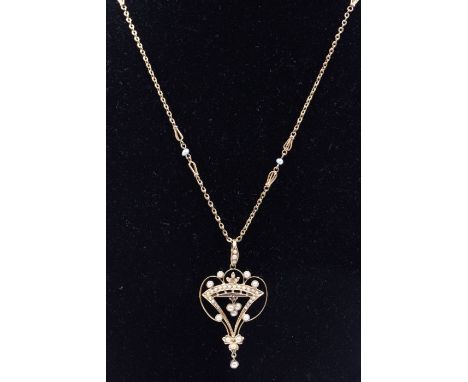An Edwardian pearl set 15ct gold pendant/brooch, comprising a wire work form inset with a coronet motif set with pearls, the 