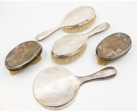 A collection of silver dressing brushes and mirror to include; A matching pair of brushes, both hallmarked Chester 1920 and 2
