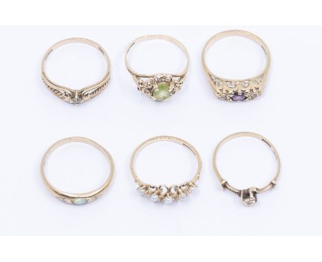 A collection of six vintage tone set 9ct gold rings to include a ruby and diamond three stone ring, size M, along with variou