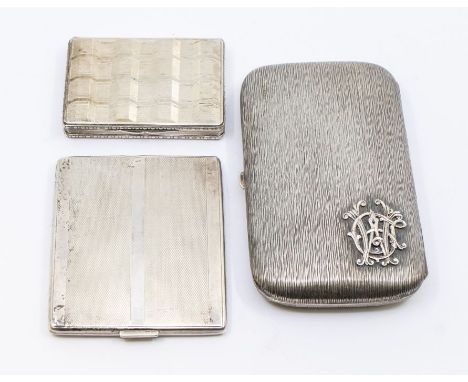 A collection of German silver to include; a large textured 'bark' like designed 800 standard cigar case with overlaid monogra