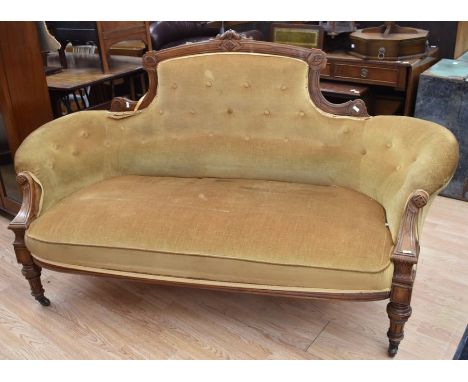 A late Victorian parlour sofa chair, button-back and covered with mustard fabric.