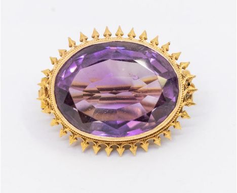 An early 20th century amethyst and gold brooch, oval mixed cut stone within a arrow like border, unmarked probably 15ct gold,