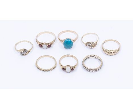 A collection of eight 9ct gold gem set rings to include two opal and garnet three stone rings, sizes N, T, a three stone diam