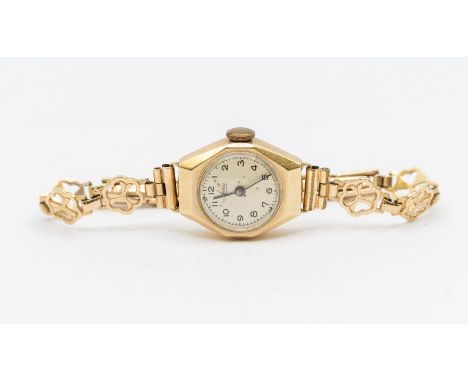 A ladies 9ct gold vintage Avia wristwatch, round champagne dial with Arabic number markers, case approx 17mm, to a fancy dais