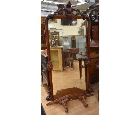 A 19th century, wall-hanging, on stand, mahogany dressing mirror with original glass, scrolled floral top and sides, a base s