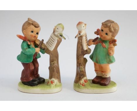 Two Hummel/Goebel style figures depicting children with violins&nbsp; (violin broken off little girls hand - fingers also bro