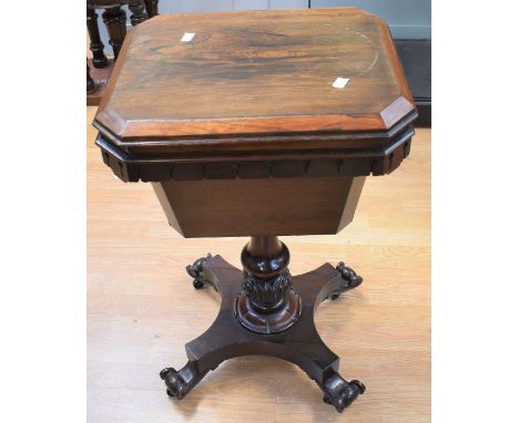 A mid-19th century mahogany sewing table with carved stem on four splayed legs with castors