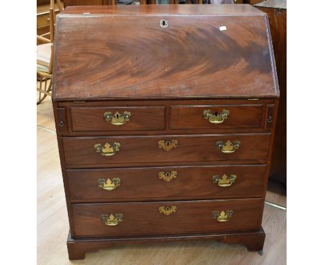 George III mahogany bureau. Comes with drop down writing slope to reveal paper and pen compartments, secret panels above two 