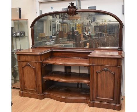 A large red mahogany mid-Victorian mirror-backed sideboard with two pedestal cupboards, one either side, and three central op