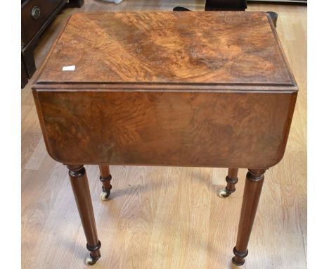 A 19th century walnut sewing/work table with drop-leaf sides, two side drawers and dummy cupboard door, turned legs and casto