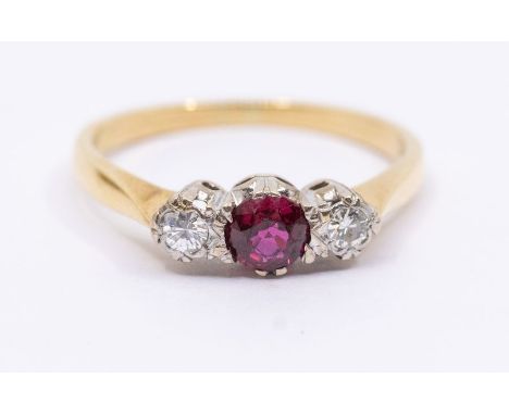 A diamond and ruby three stone 18ct gold, comprising a central round cut ruby, approx 4mm, with two round brilliant cut diamo