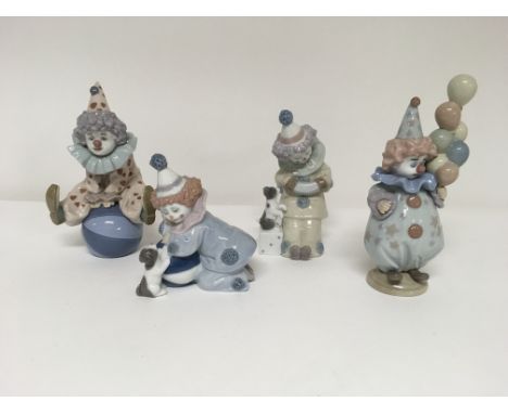 A collection of four Lladro clowns, one seated on a ball, one with balloons, and two playing with a puppy.(4)