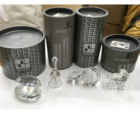 A collection of Swarovski including a shell pearl and other boxed ornaments including a polar bear, pram, bear and dog.