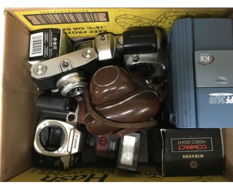 A box of camera equipment and bodies.
