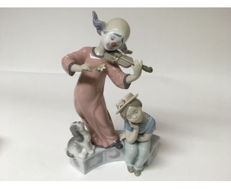A Lladro figure of a clown playing an instrument with a child seated and a dog