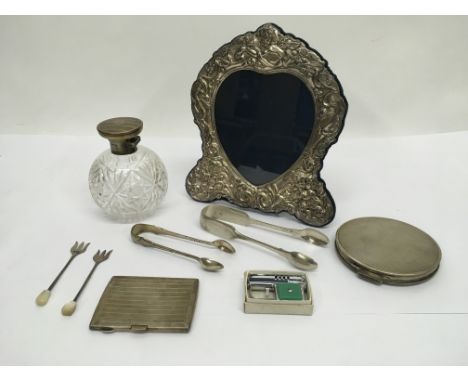 A silver photo frame, silver topped scent bottle, silver compact etc.