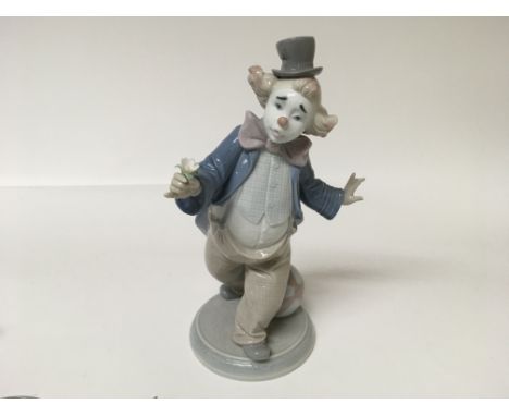 A Lladro figure of a clown playing with a ball
