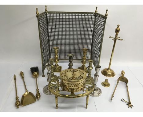 A collection of brassware including candlesticks and fire tools