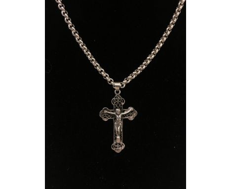 A large silver crucifix pendant on a silver chain.