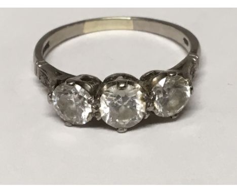 A ladies three stone diamond ring with three brilliant cut diamonds, set in platinum. Ring size R. 