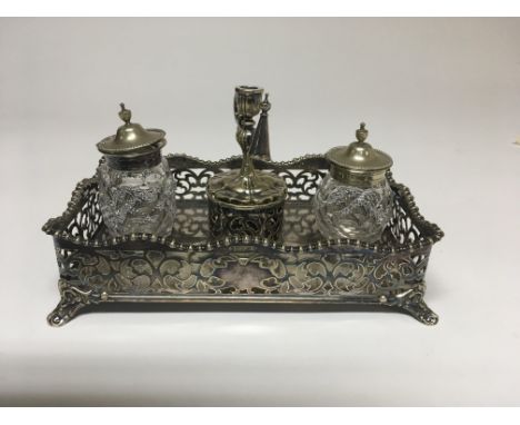 A Georgian style silver plated desk set with with chamber stick glass bottles inset into a gallery tray