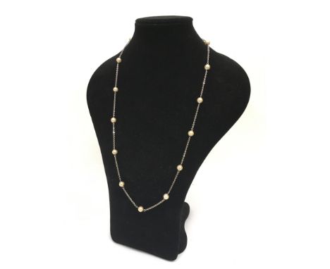 A silver chain set with simulated pearl beads, approx length 79cm.