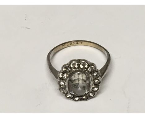 A Ladies 9ct Gold and silver dress ring set with a central stone possible a white sapphire. flanked by smaller stones. 