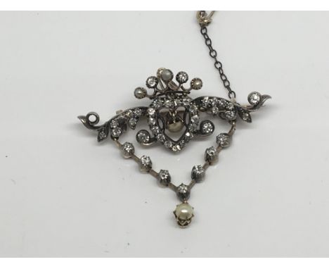 A quality late Victorian diamond and seed pearl brooch with a central open heart with diamond drops (one diamond missing) 