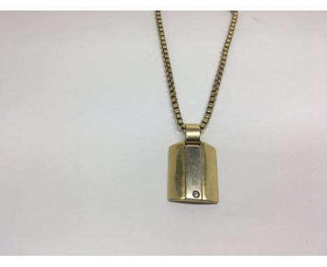A modern 18ct gold pendant set with a small diamond attached with a 9ct gold chain, 30g total weight approximately.