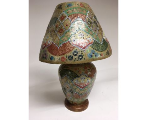 An Indian lamp and base made of skin, hand decorated