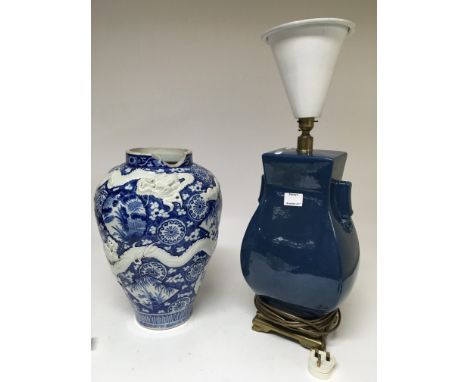 A large Chinese blue and white vase applied with a dragon, extensively damaged and a blue glazed lamp