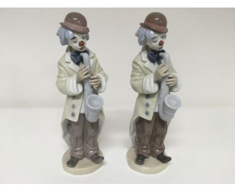 Two identical Lladro figures of a clown playing a musical instrument (2)