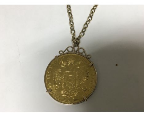 A Gold Austrian 10 Corona coin dated 1915 in a 9ct Gold Mount with attached chain. 