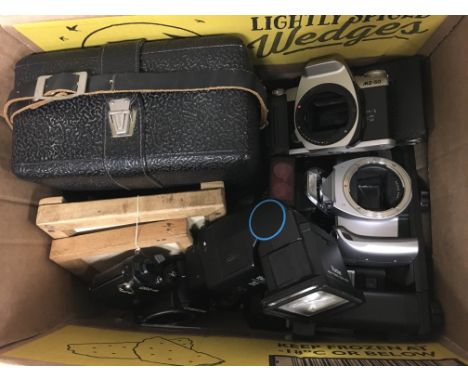 A box of camera equipment and bodies.