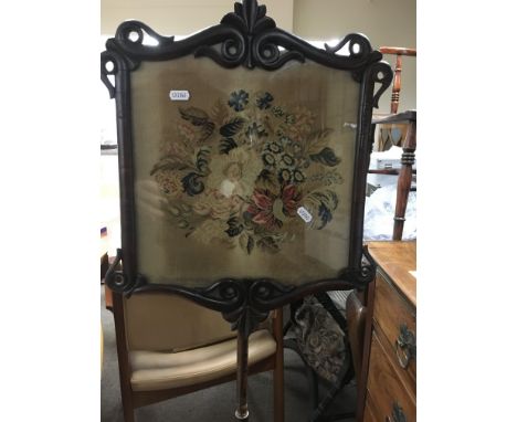 A Victorian pole fire screen with floral tapestry 
